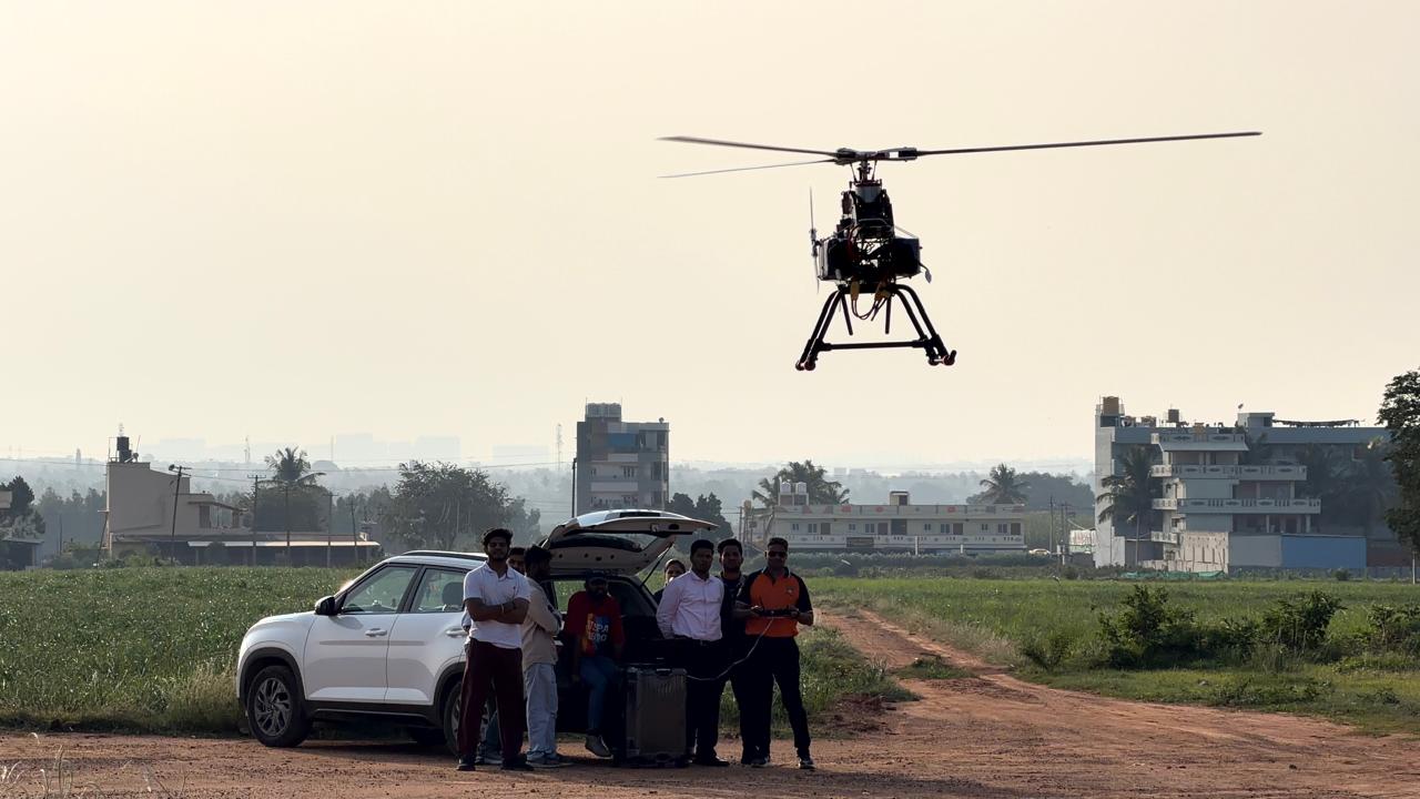 Test-bed helicopter in flight above the Xinfiniti AeroSpace trial team